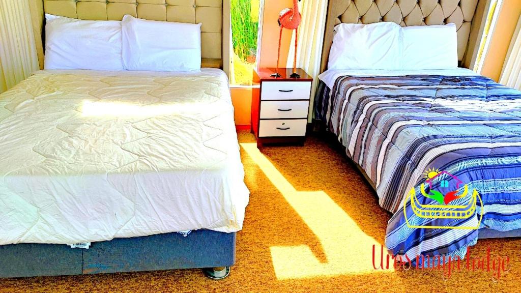 Postel nebo postele na pokoji v ubytování Uros Maya Lodge