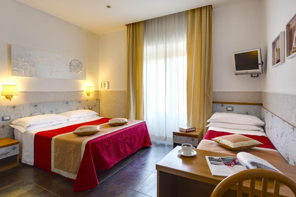 Postel nebo postele na pokoji v ubytování Hotel Marcantonio