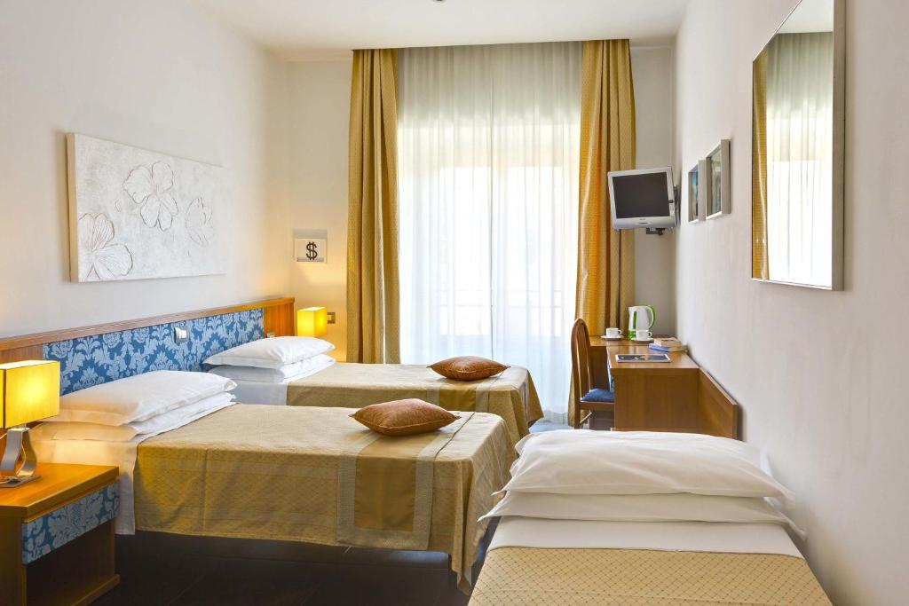 Postel nebo postele na pokoji v ubytování Hotel Marcantonio