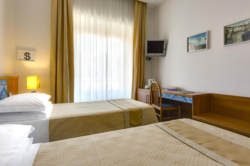 Postel nebo postele na pokoji v ubytování Hotel Marcantonio