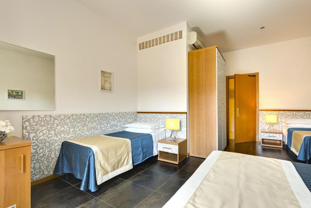 Postel nebo postele na pokoji v ubytování Hotel Marcantonio