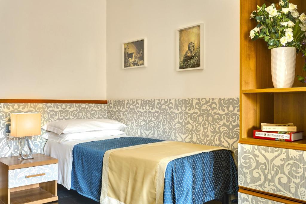 Postel nebo postele na pokoji v ubytování Hotel Marcantonio