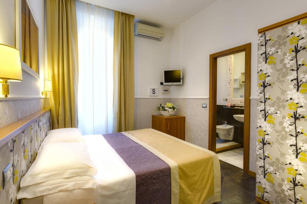 Postel nebo postele na pokoji v ubytování Hotel Marcantonio