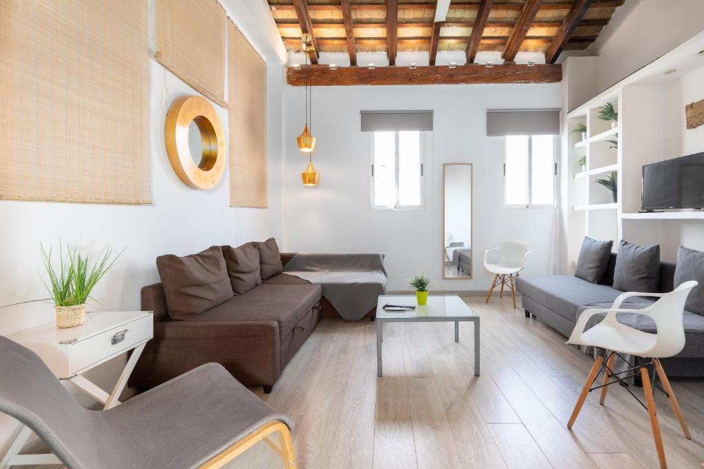 a living room with a couch and a table at Barón Suites Ruzafa in Valencia