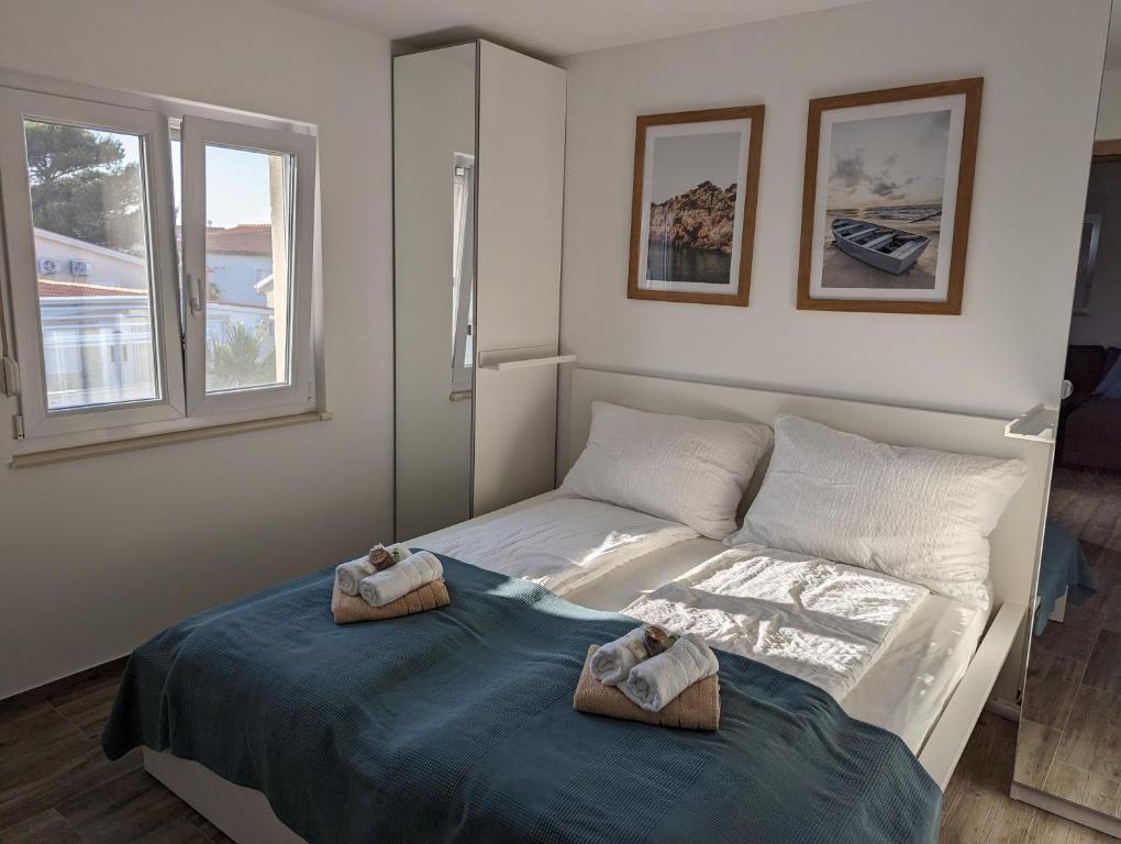 a bedroom with a bed with towels on it at Apartment LIPA in Vir