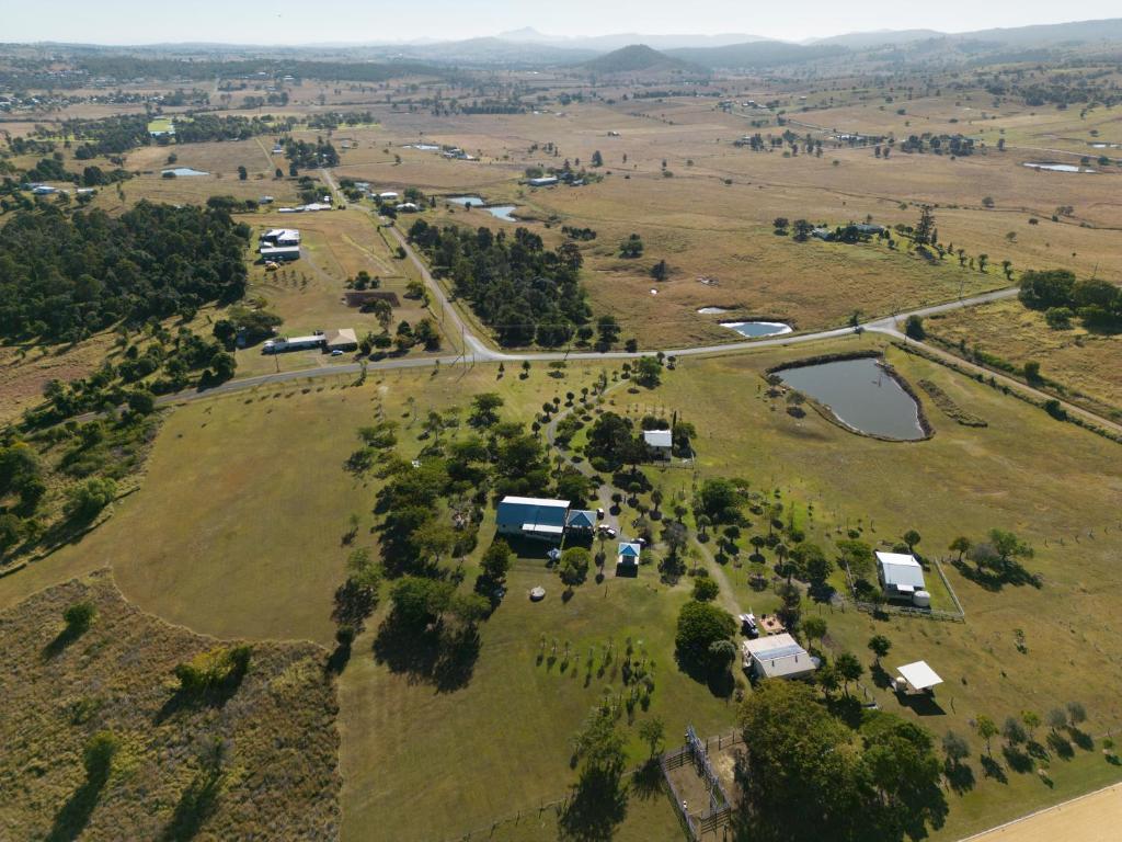 an aerial view of a farm with vehicles on a field at Milford Country Cottages in Milford