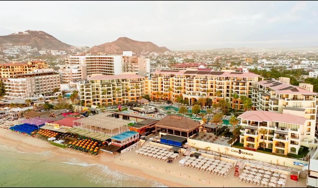 an aerial view of a beach with hotels and buildings at Casa Dorada Los Cabos Resort & Spa in Cabo San Lucas