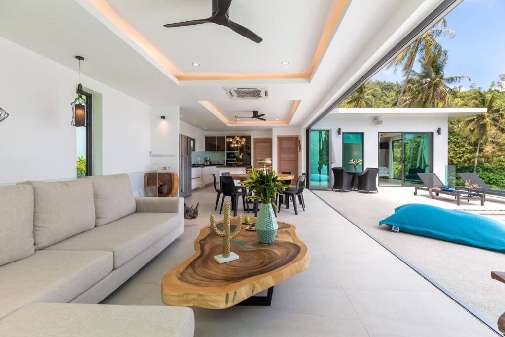 a living room with a couch and a table at Villa Coco in Lamai