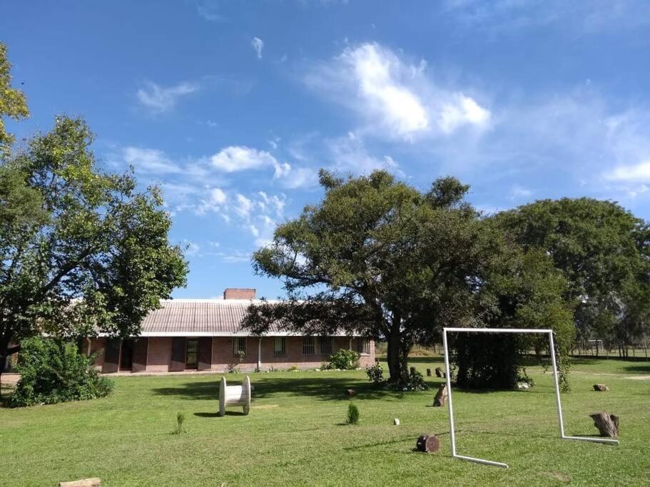 a field with a soccer goal in front of a building at Quinta El Descanso in General Alvarado