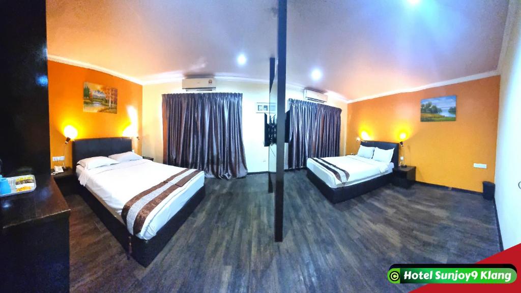 Postel nebo postele na pokoji v ubytování Hotel Sunjoy9 Klang