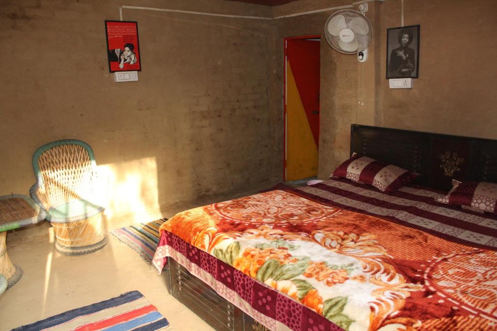 ランズドーンにある11 Gaon Mudhouse Homestayのベッドルーム1室(ベッド1台、椅子付)