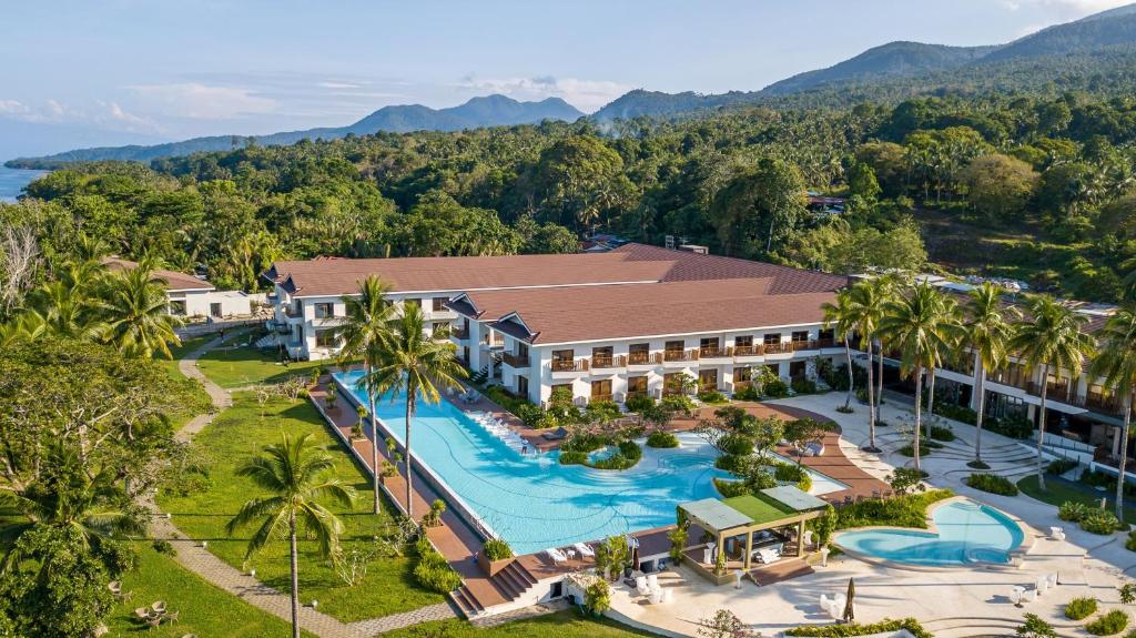 an aerial view of a resort with a swimming pool at Nouveau Resort in Mambajao