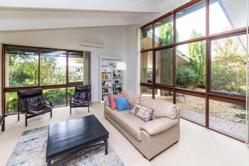 a living room with a couch and a table at Nixon House in Benalla