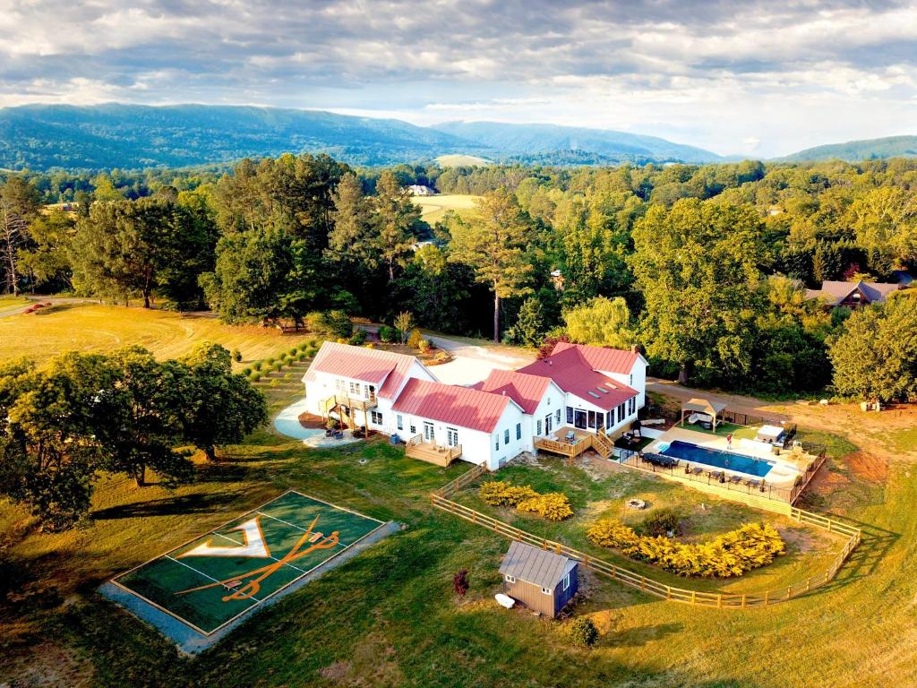 an aerial view of a house with a yard at Wine Country Modern Farmhouse on 10 Acres and Pool in Afton