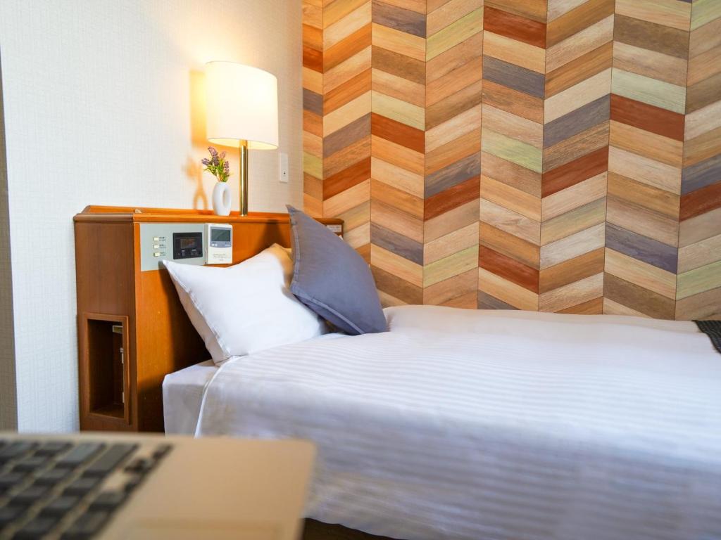 Postel nebo postele na pokoji v ubytování Hotel New Gaea Itoshima