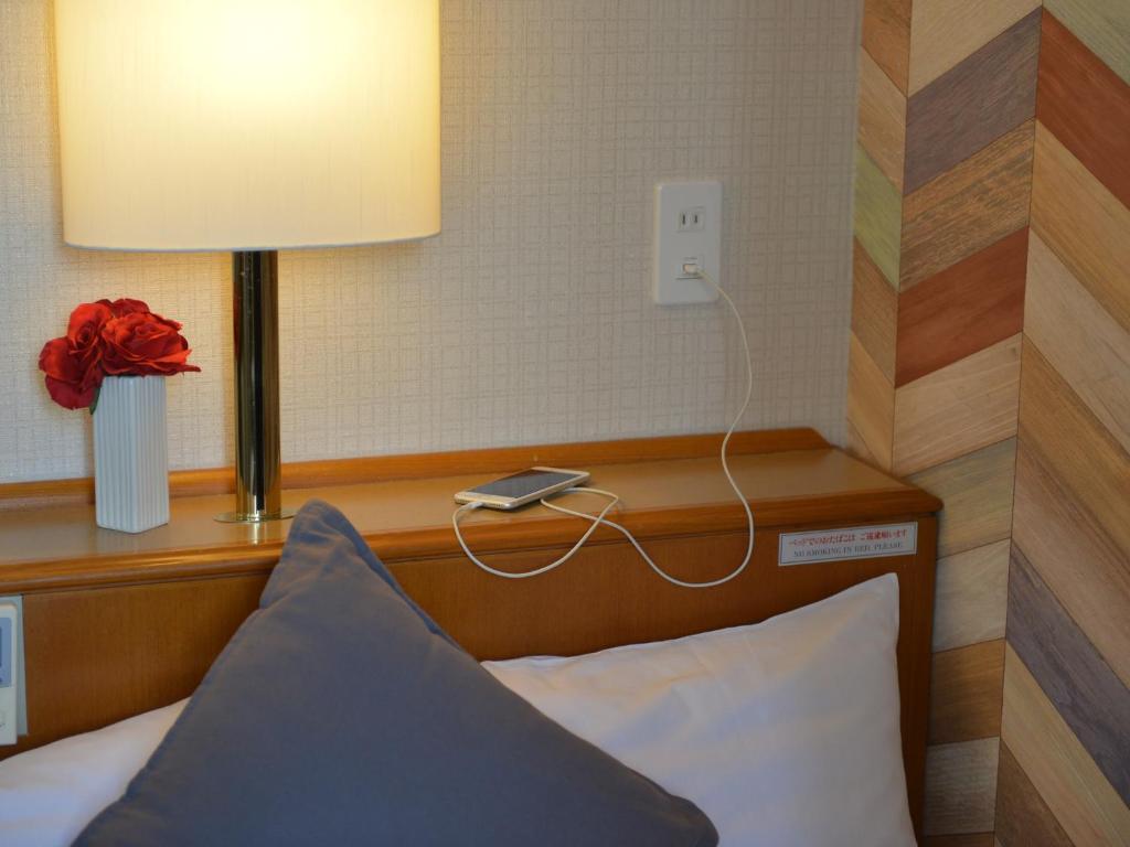 Postel nebo postele na pokoji v ubytování Hotel New Gaea Itoshima