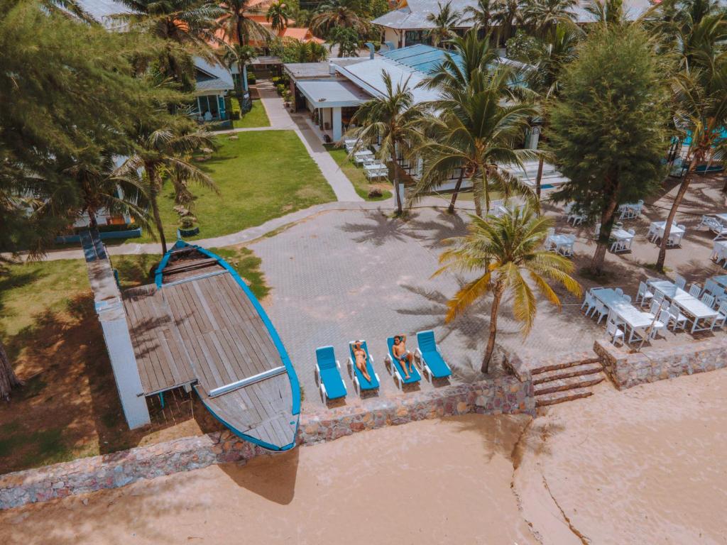 an aerial view of a resort with chairs and a pool at Chaolao Tosang Beach Hotel in Chao Lao Beach