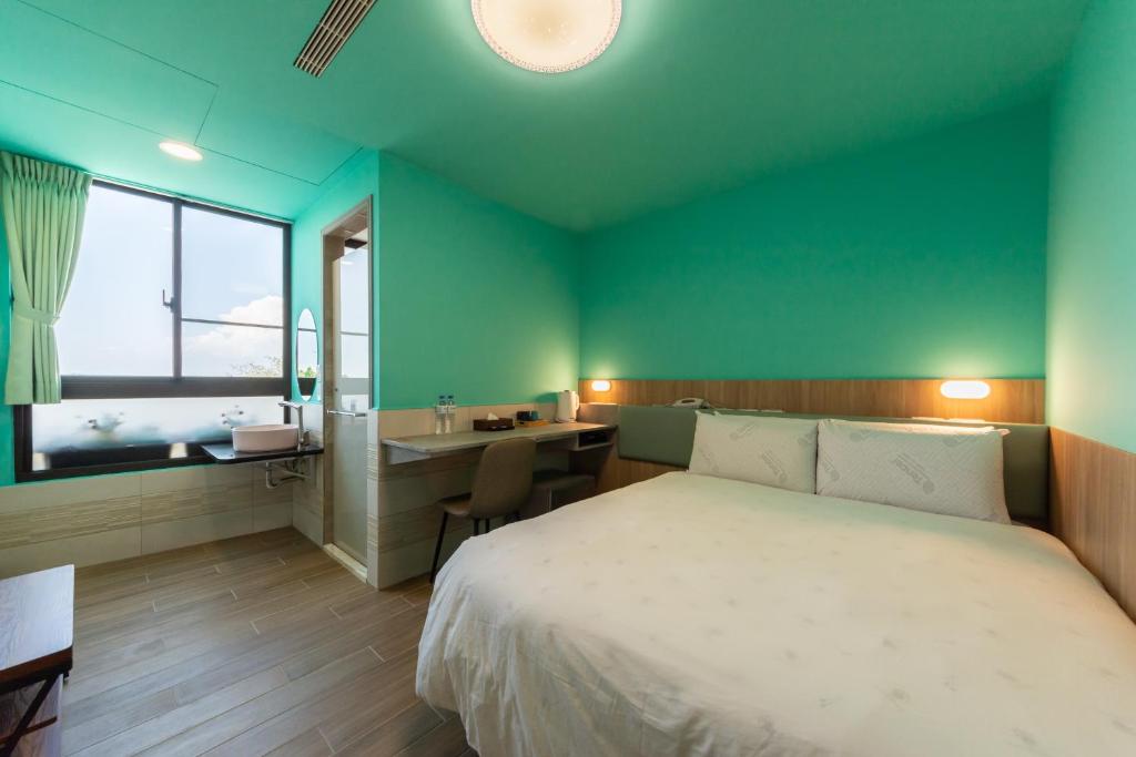 Postel nebo postele na pokoji v ubytování Qun Xiang Hotel