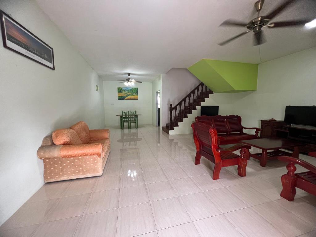 a living room with a couch and a dining room at Leng Leng Homestay in Sibu
