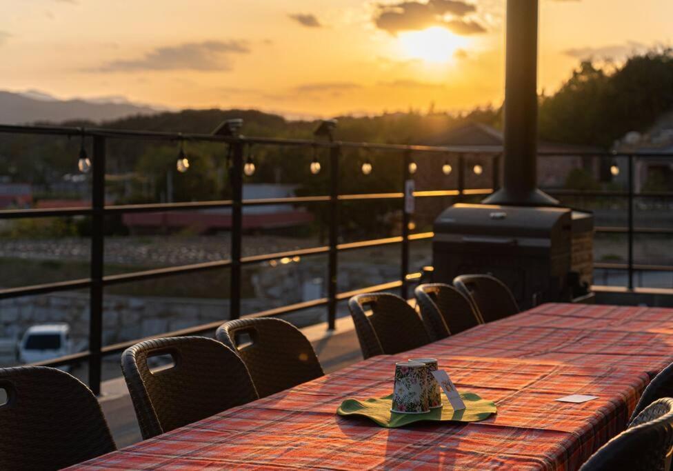 a table with a cake sitting on top of a balcony at Dignitas Luxury Villa in Gangneung