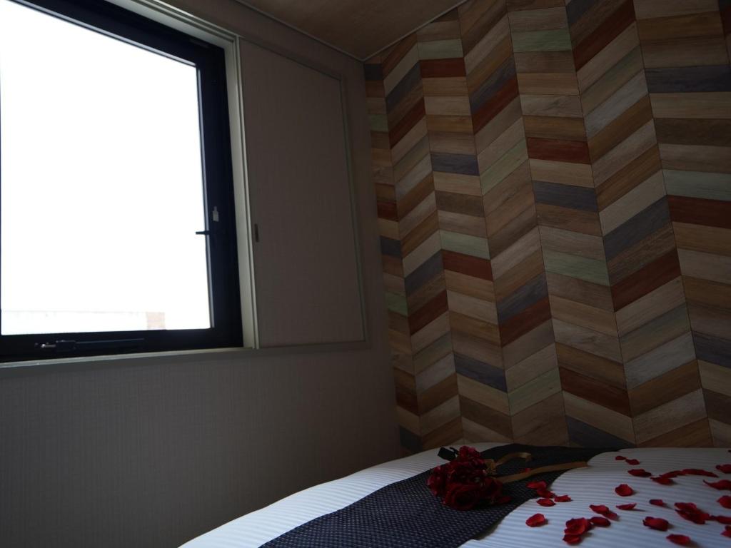 Postel nebo postele na pokoji v ubytování Hotel New Gaea Itoshima