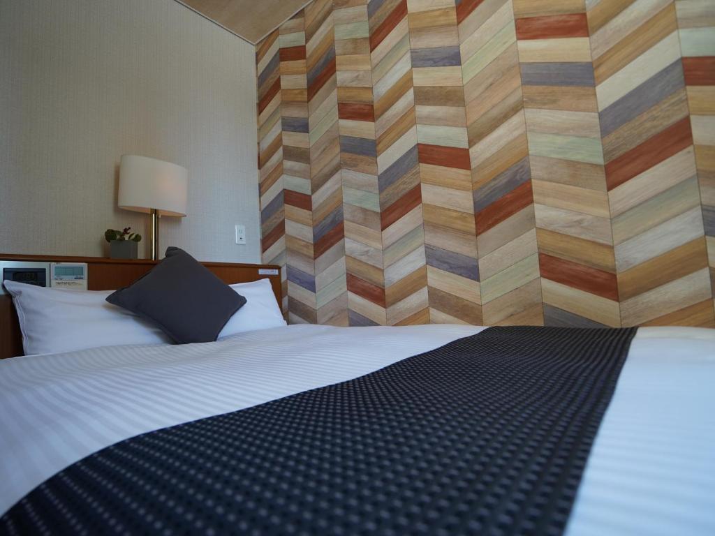 Postel nebo postele na pokoji v ubytování Hotel New Gaea Itoshima