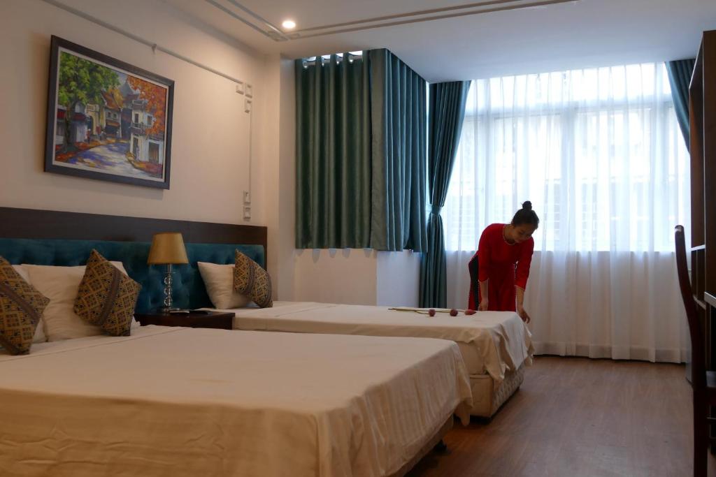 Postel nebo postele na pokoji v ubytování Maison d'Hanoi Hotel