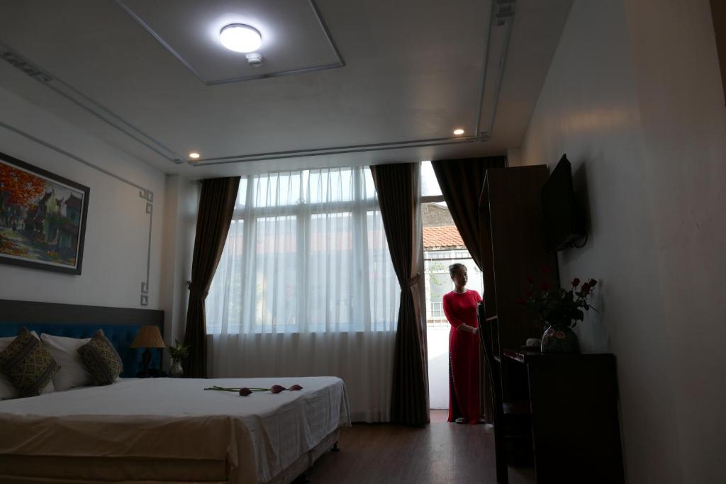 Postel nebo postele na pokoji v ubytování Maison d'Hanoi Hotel