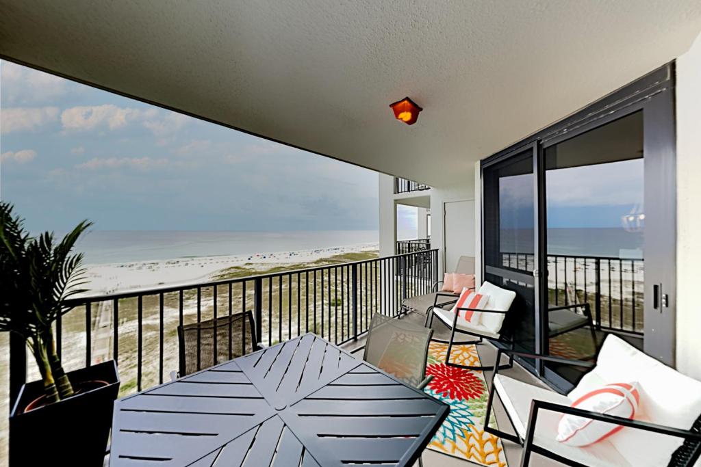 a balcony with a table and a view of the beach at Phoenix VI 807 in Orange Beach