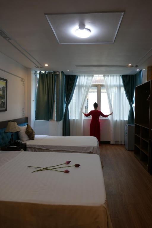 Postel nebo postele na pokoji v ubytování Maison d'Hanoi Hotel