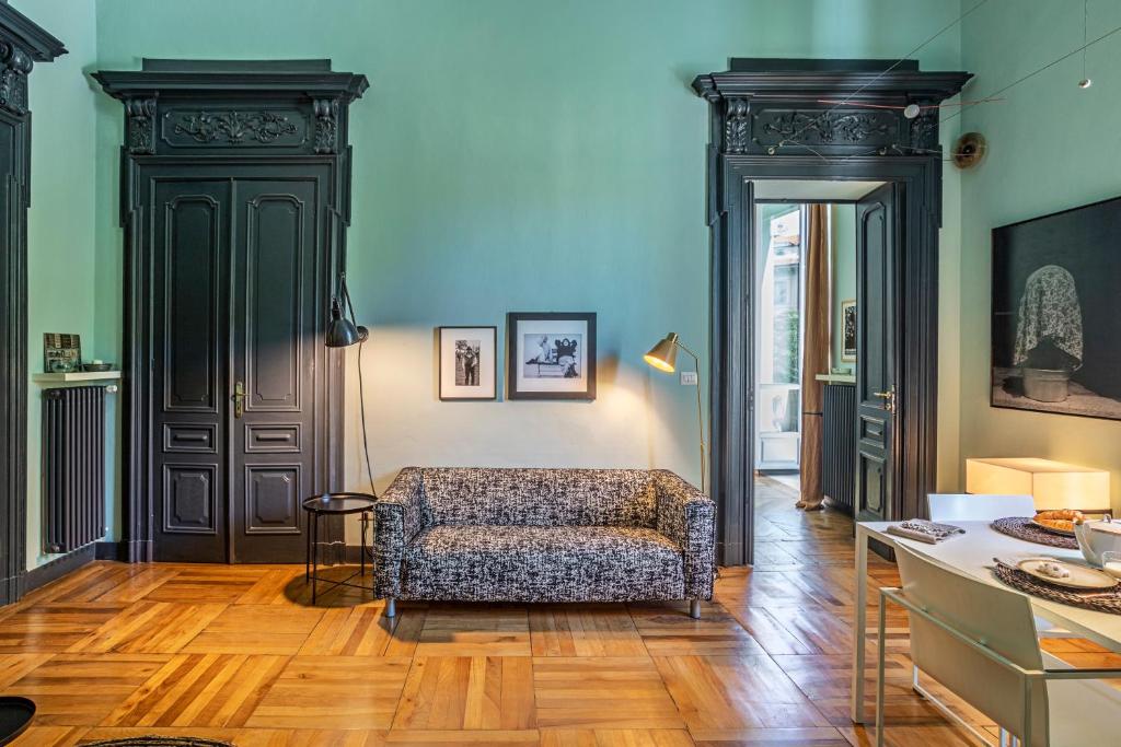 a living room with a couch and a table at LAVI' 82 Apartament in Turin
