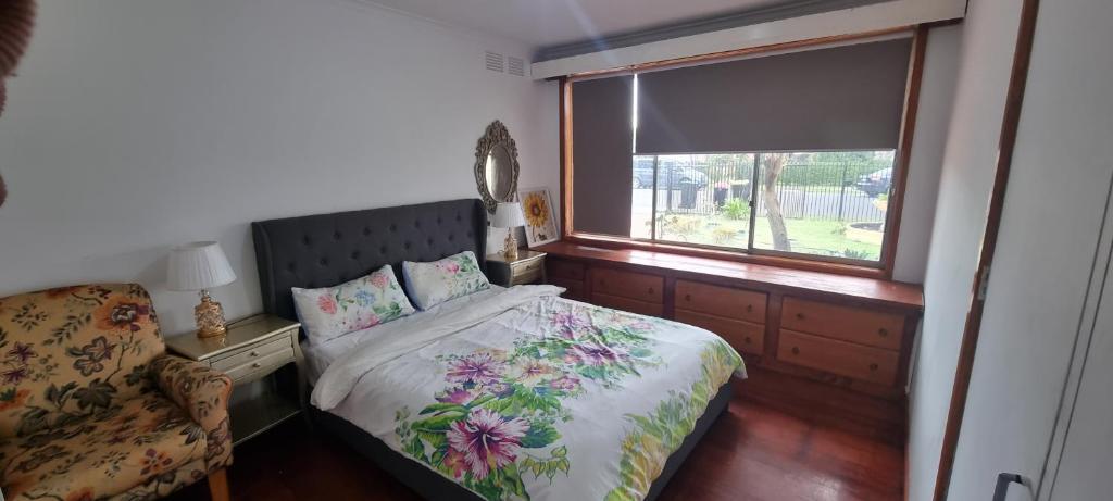 a bedroom with a bed and a window at Entire 3 bed rooms unit -Rosy house 1 in Noble Park