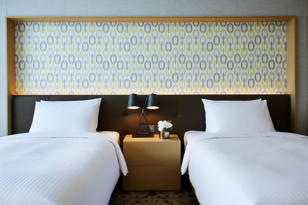 Postel nebo postele na pokoji v ubytování Marriott Jeju Shinhwa World Hotel