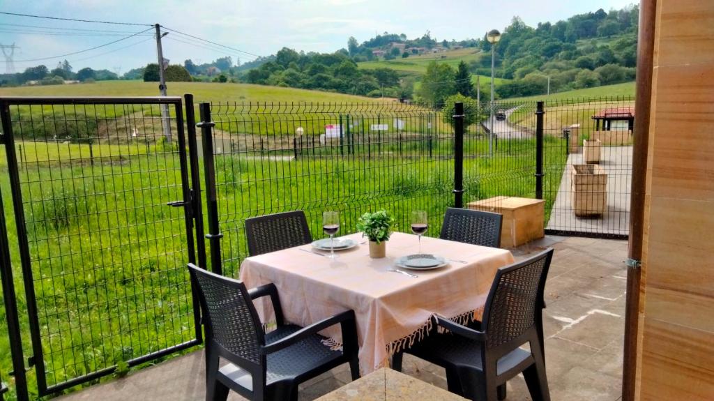 a table on a patio with a view of a field at El Mirador del Valle, a 9 min de Comillas in Comillas