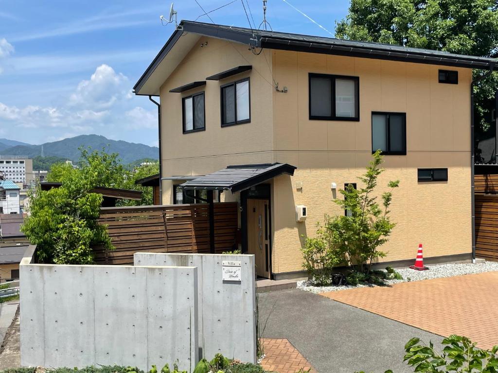 a house with a fence in front of it at Villa Sense of wonder in Takayama