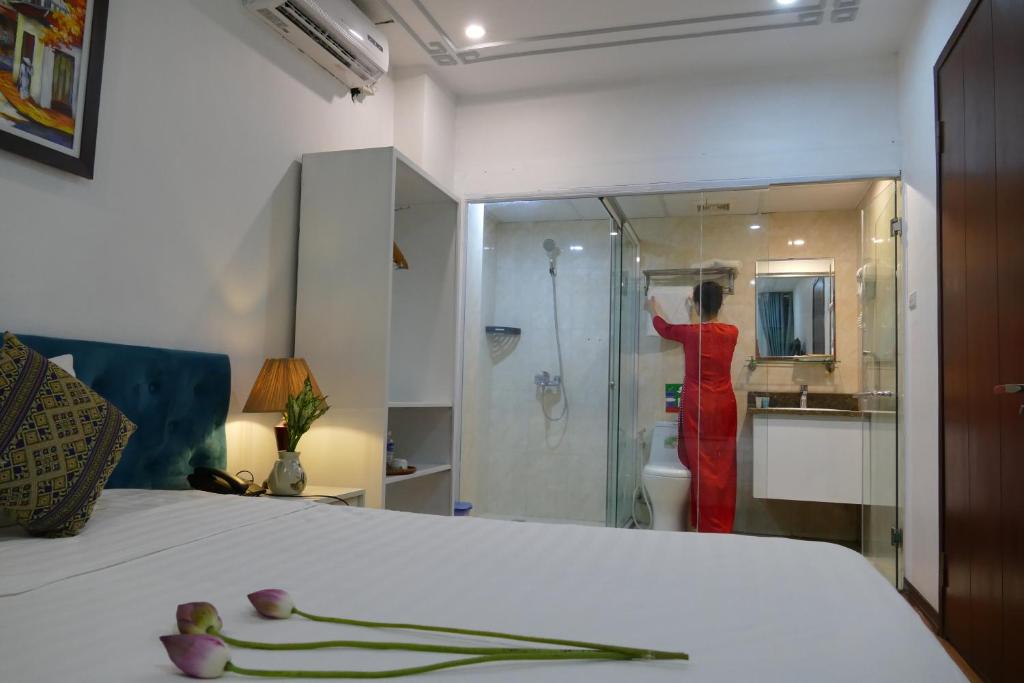 Postel nebo postele na pokoji v ubytování Maison d'Hanoi Hotel