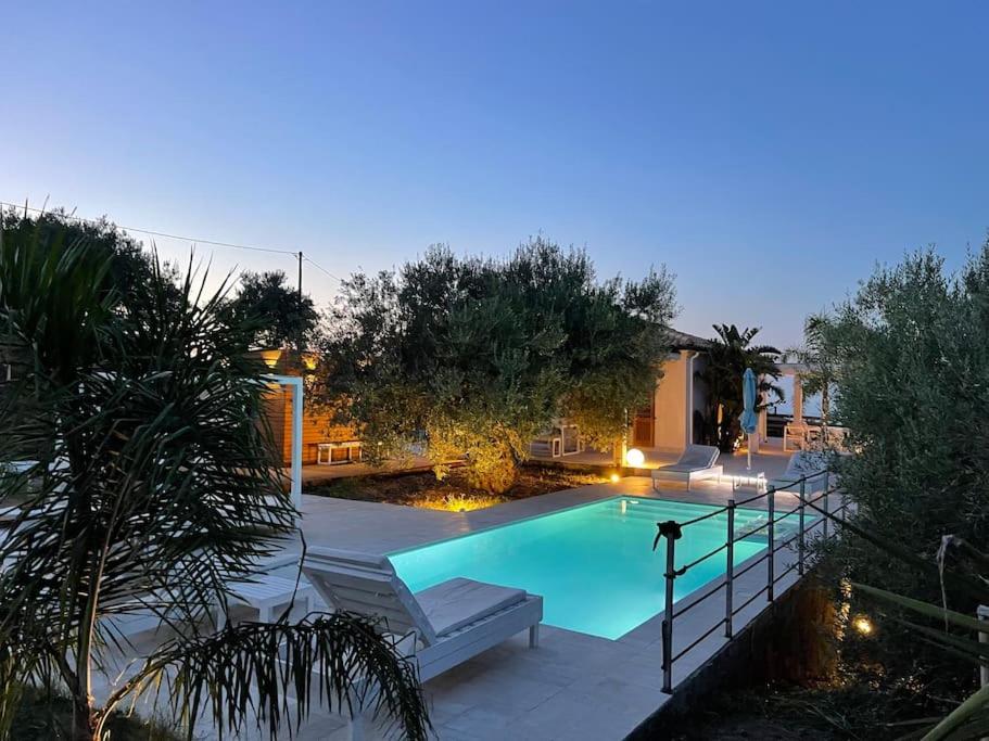 una piscina en un patio trasero por la noche en Villa Sicily, gorgeous villas with Private Pool, near Cefalu', en Finale
