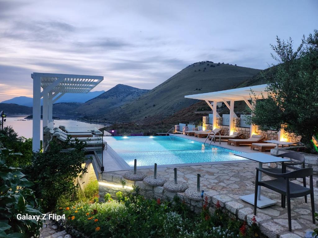a swimming pool with a view of a mountain at Vila D Boutique Hotel in Qeparo