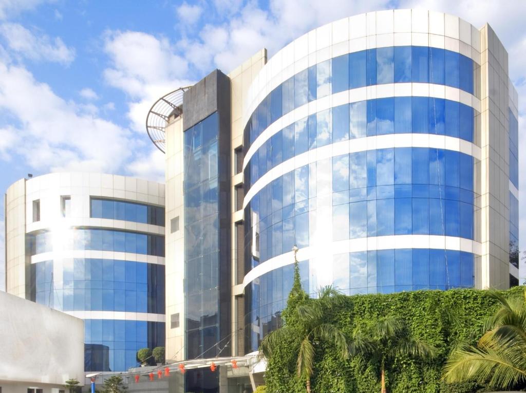 a tall glass building with a lot of windows at Peninsula Grand in Mumbai