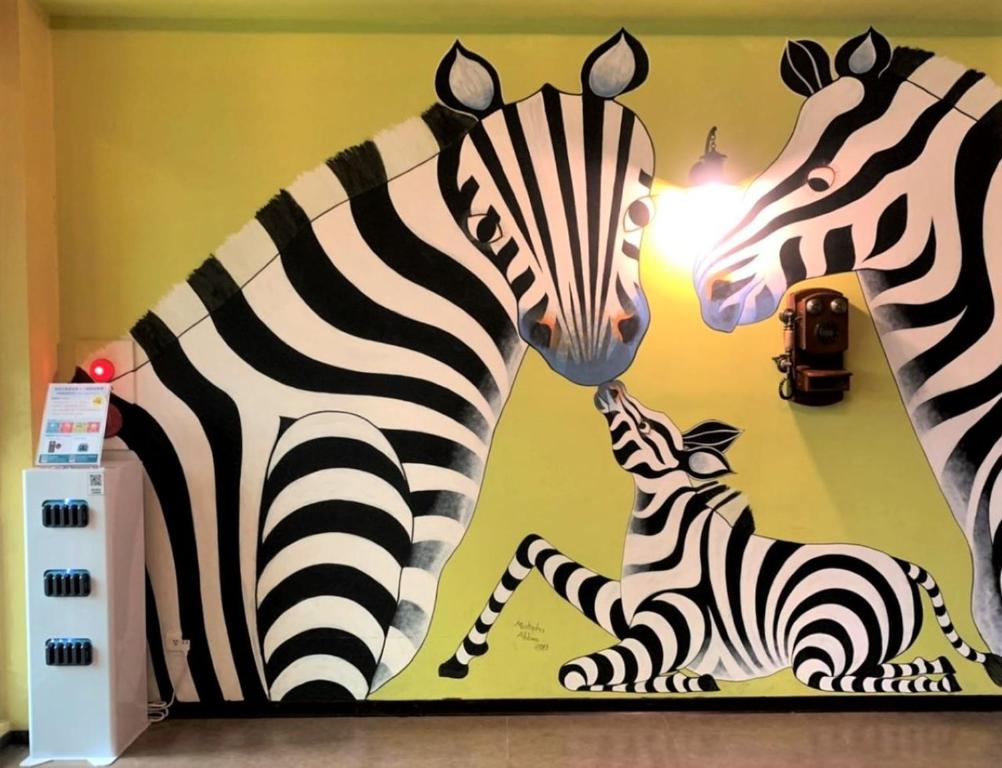 two statues of zebras and a baby zebra on a wall at Leofoo Resort Guanshi in Guanxi