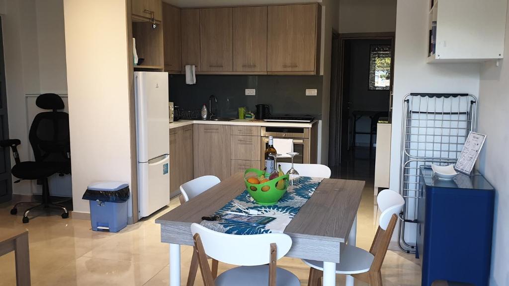 a kitchen with a table with a bowl of fruit on it at Connie's Beach House in Kos Town