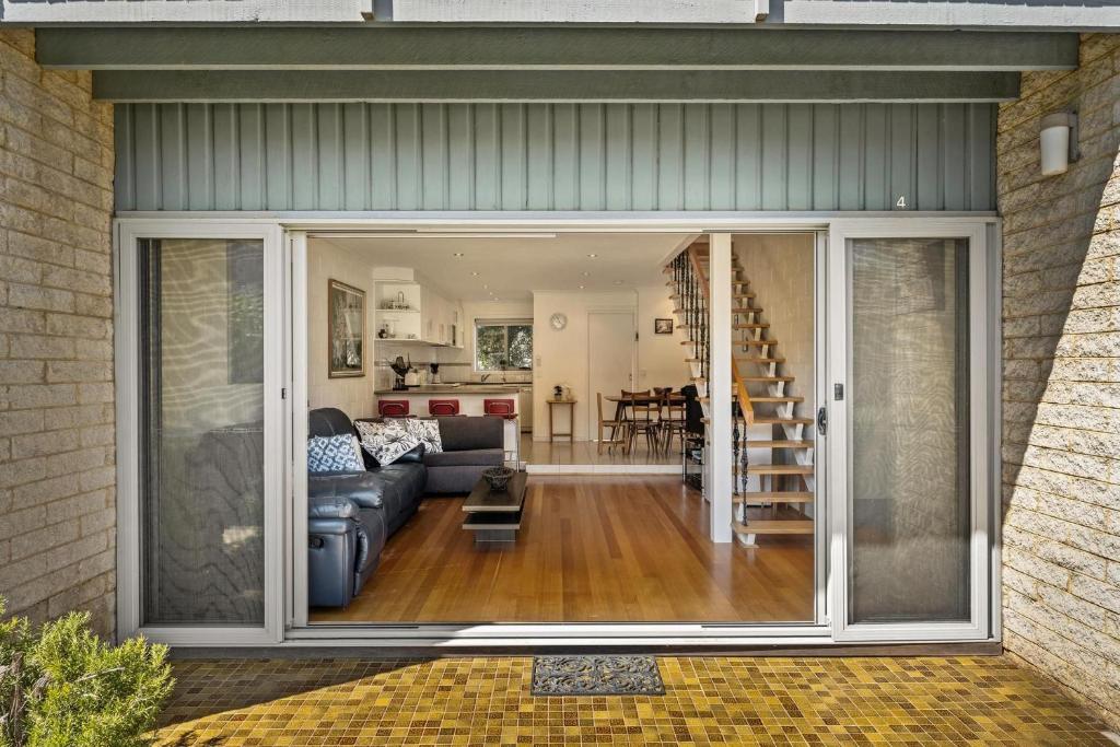 a living room and dining room with sliding glass doors at 4 of 5 Walpole Street in Cowes