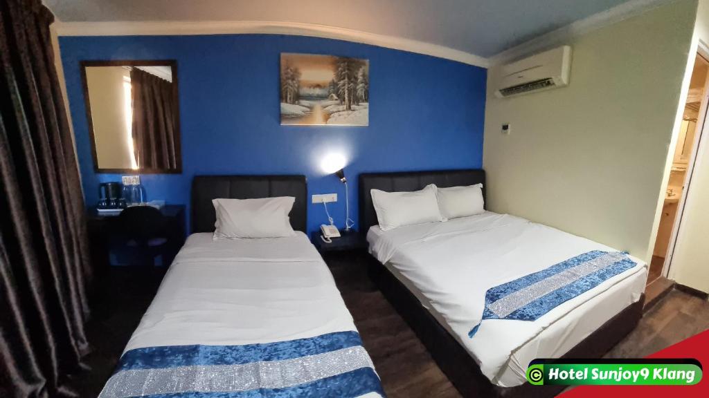 Postel nebo postele na pokoji v ubytování Hotel Sunjoy9 Klang