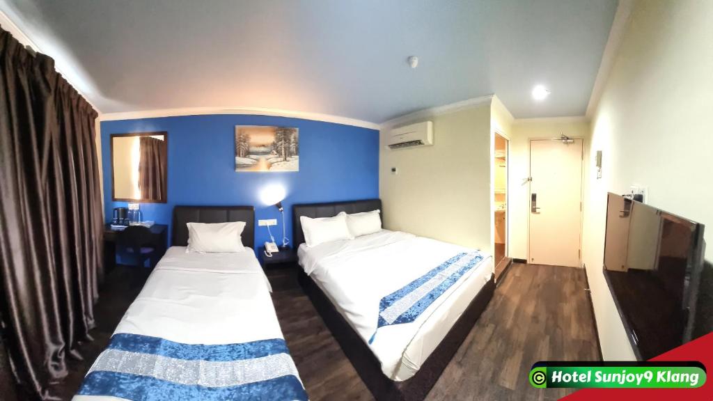 Postel nebo postele na pokoji v ubytování Hotel Sunjoy9 Klang