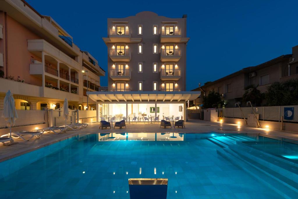 ein Pool vor einem Hotel in der Nacht in der Unterkunft Hotel Carducci in Tortoreto Lido