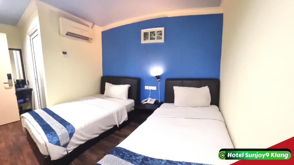 Postel nebo postele na pokoji v ubytování Hotel Sunjoy9 Klang