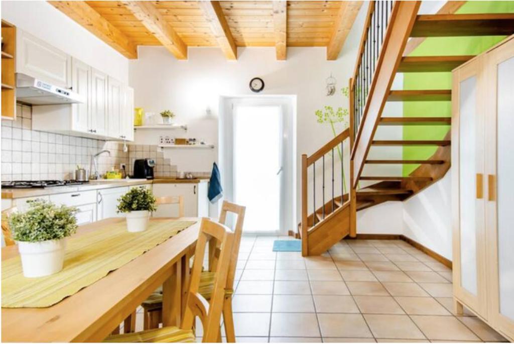 eine Küche mit einem Holztisch und einer Treppe in der Unterkunft B&B Ai Tigli in Udine