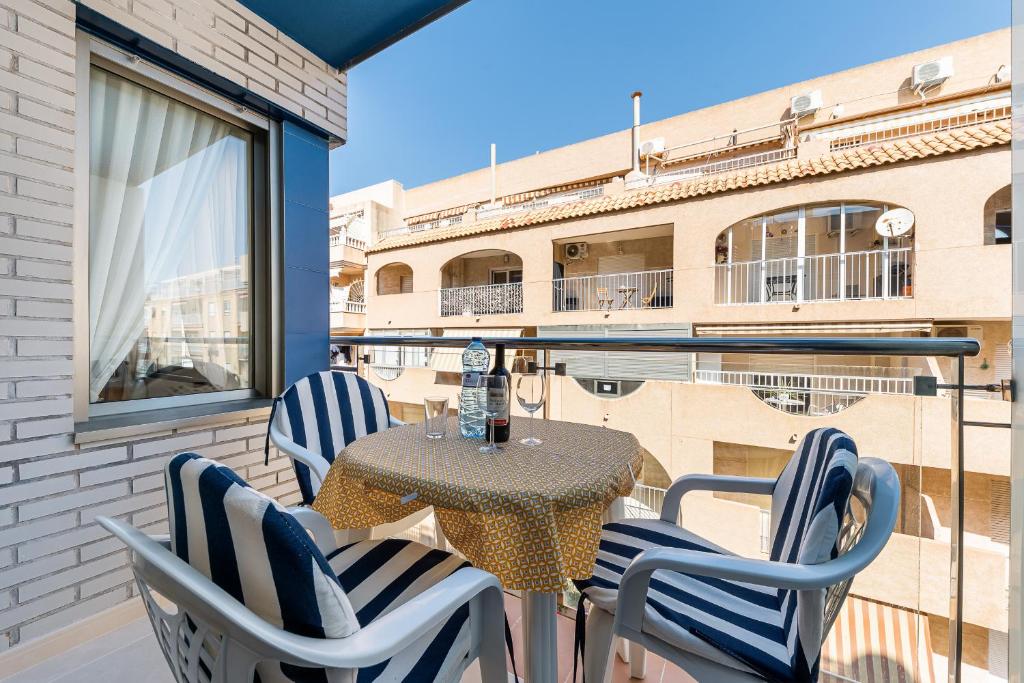 taras ze stołem i krzesłami na balkonie w obiekcie Apartament Playa de Los Locos w mieście Torrevieja