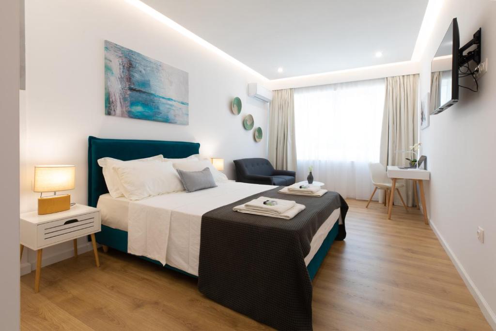 a bedroom with a bed and a table in it at Minimal apartment in Plaka in Athens