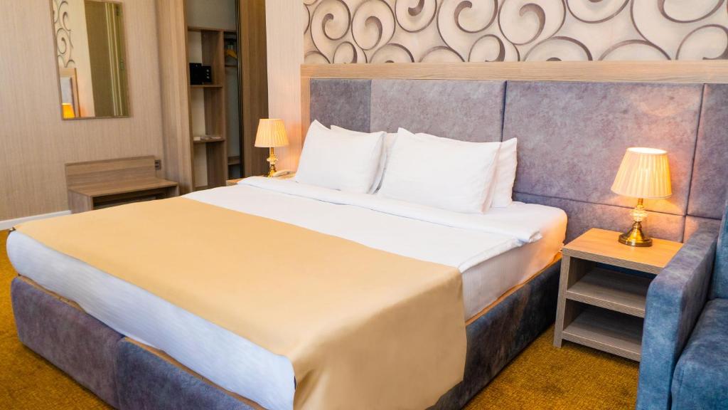 Postel nebo postele na pokoji v ubytování Grand Midway Hotel